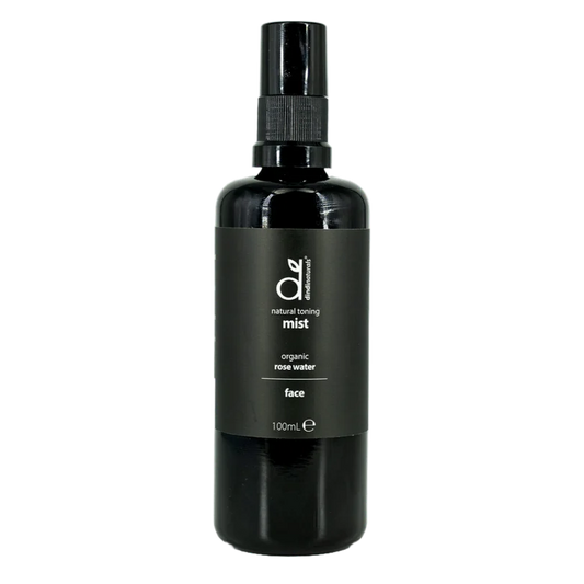 Black bottle of organic rose water mist on a white background