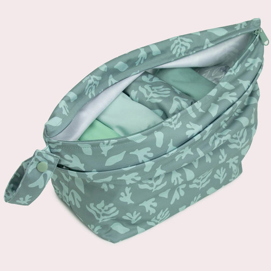 Green patterned bag on a light pink background